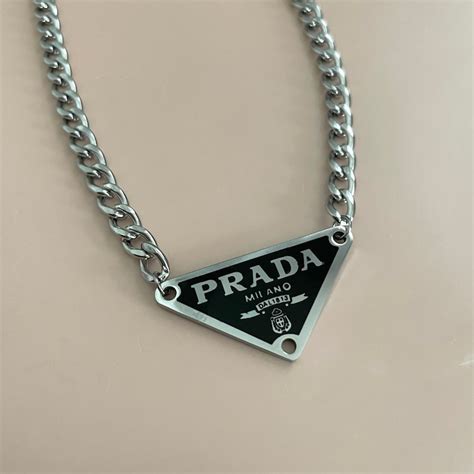 prada triangle pendant.